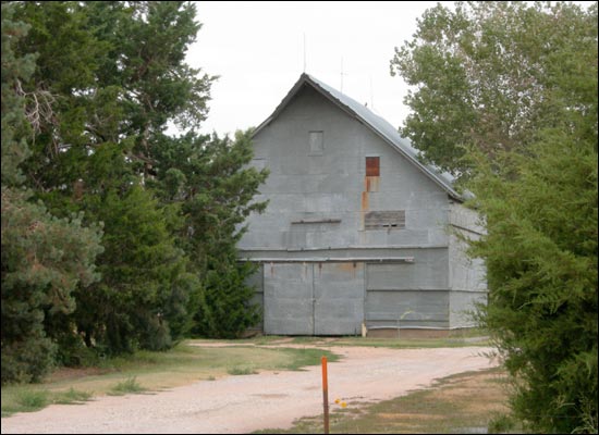 This barn, built by Ben C. Unruh early in the 20th century on his estate just north of Pawnee Rock's city limit and just south of Pawnee Rock State Park, is a fine example of utilitarian design. The barn was originally wood sided and later covered with galvanized metal. Photo copyright 2006 by Leon Unruh.