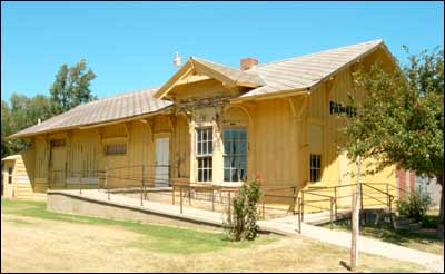 The Pawnee Rock depot, sitting downtown after being moved from the Santa Fe Railroad tracks in the 1970s. Photo copyright 2006 by Leon Unruh.