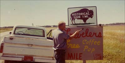 Tom Flick puts up a sign advertising coffee for the Lions Club.