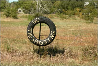 Tire that tells people not to trespass. Southwestern Pawnee Rock, August 2006. Photo copyright 2006 by Leon Unruh.