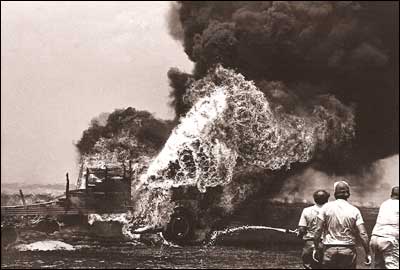 A wheat truck burns in a field north of Larned in the middle 1970s. Photo copyright 1976 by Leon Unruh.
