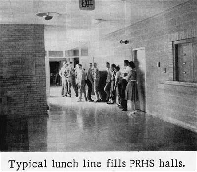 The high school lunch line stretches back into the hallway in 1966.