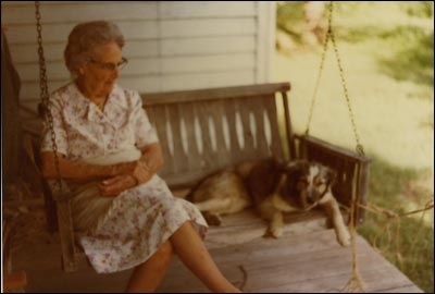 Lena Unruh with Shep on her porch swing, about 1979. Photo by Elgie Unruh.
