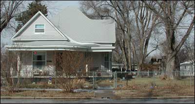 The Morris chinchilla boxcar was still in the back yard of this home on Santa Fe Avenue in 2005, now a weatherbeaten brown-gray and visible behind the tree on the right.