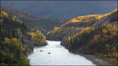 Vacationers on Nenana River rafts make their way north out of the Alaska Range near Denali National Park. Photo copyright 2011 by Leon Unruh.