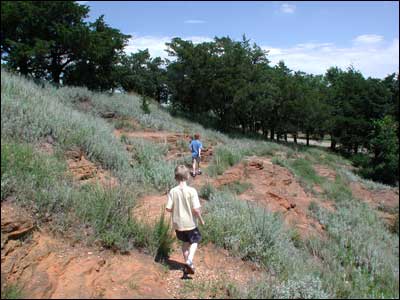 Boys scamper on the east side of the Rock. Photo copyright 2009 by Leon Unruh.