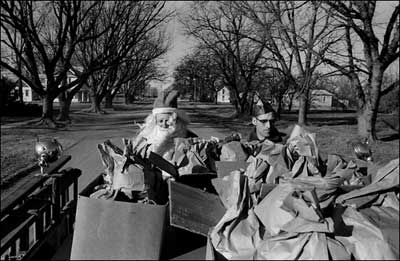 Santa Claus rides the firetruck on Bismark Avenue before it turned onto Centre Street. Photo copyright 2008 by Leon Unruh.