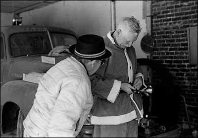 Art Sayler dresses in the Santa suit in the red-brick fire station. The truck behind him was Pawnee Rock's old truck, not the one he rode into town. Photo copyright 2008 by Leon Unruh.