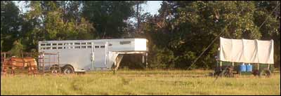 Santa Fe Trail Association wagons spend the evening along the school shelterbelt. Photo copyright 2007 by Gary Trotnic.