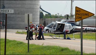 Medical personnel move Raymond Chapman to the EagleMed helicopter parked on U.S. Highway 56. Jim Dye made this photo. Copyright 2010 by Jim Dye.